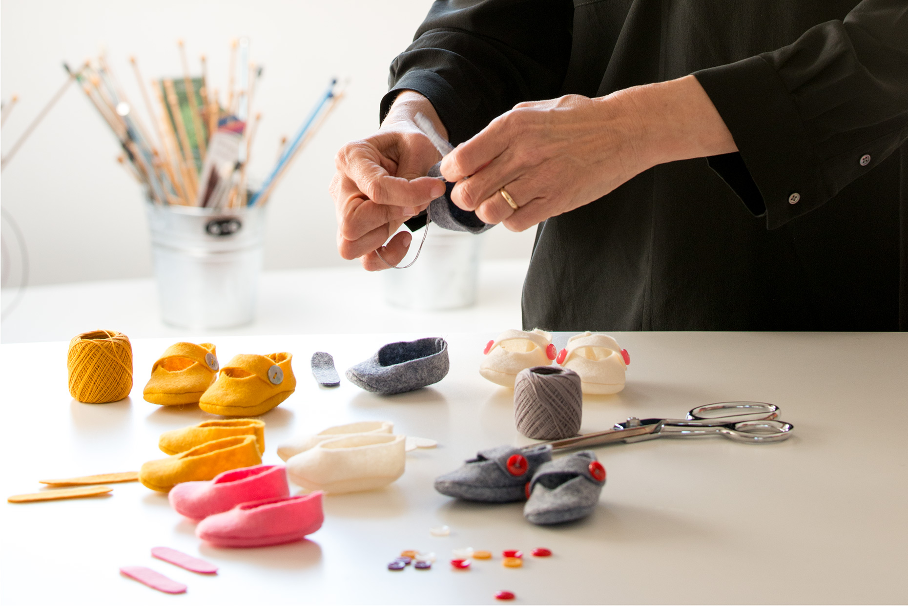 Photographer for business websites hands making doll shoes